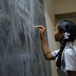 Girl at chalk board. Providiing an education. www.NextStepPh.com