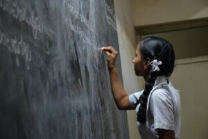 Girl at chalk board. Providiing an education. www.NextStepPh.com